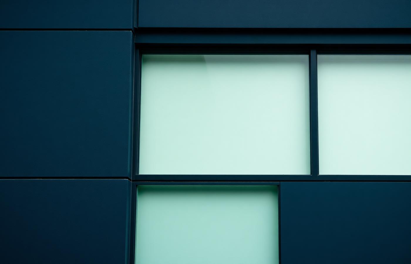 Clean architectural facade in navy and soft green